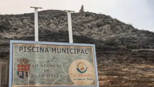 Cartell d´accés a la piscina municipal a la Vilavella, municipi desallotjat per l´incendi a la Vall d´Uixó.